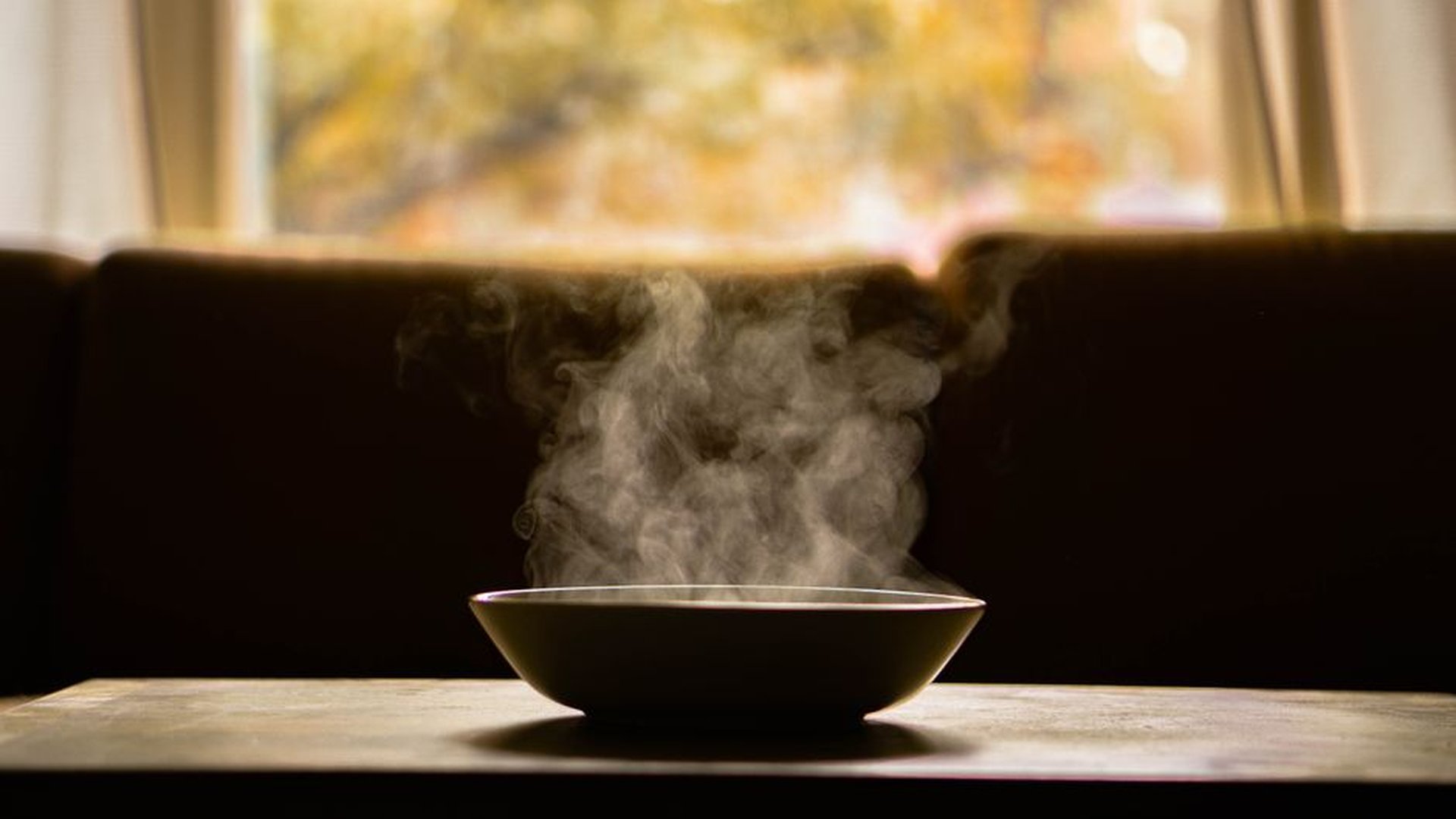 hot pot on wooden table steam from casserole dis