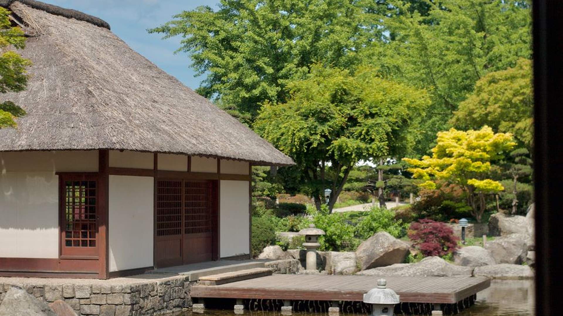wooden deck garden stones flowing water plants in