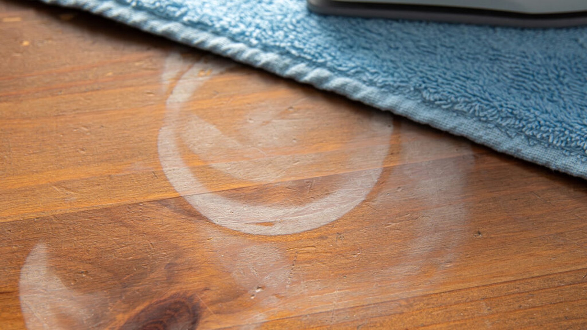 wet rag on wooden furniture   water droplets on fa